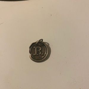 Waxing poetic charm. Silver The letter R.
